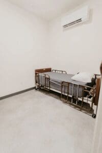 An empty room with a bed in it.