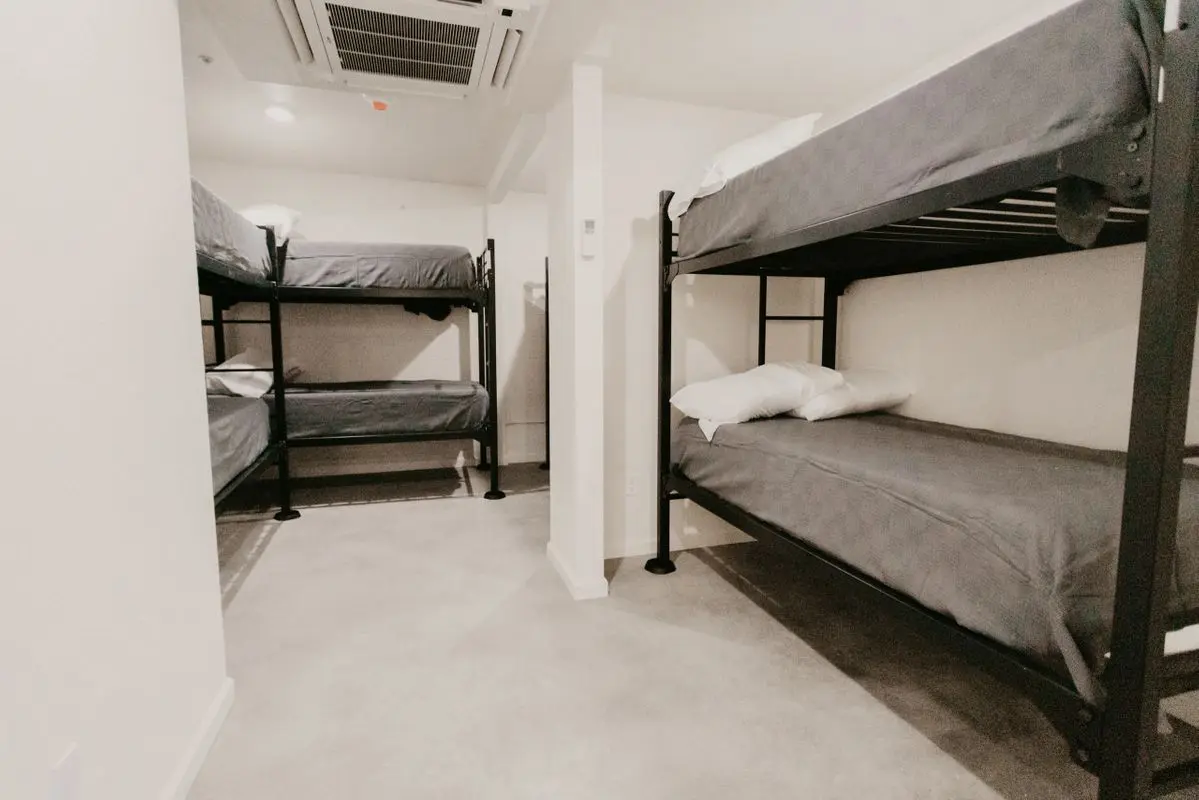 A small room with bunk beds in it.