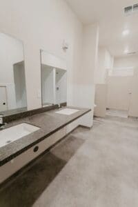 A bathroom with two sinks and mirrors.