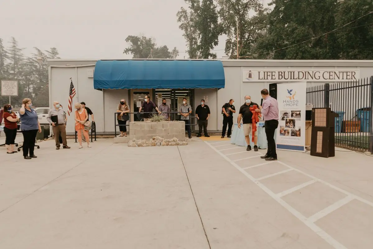 A group of people standing in front of a building.