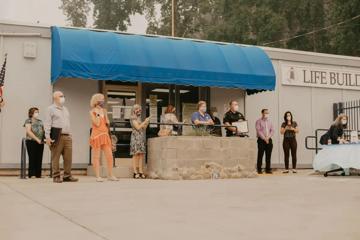 A group of people standing in front of a building.