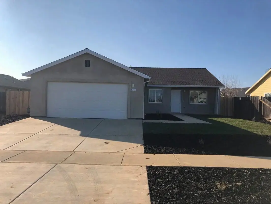 A home with two garages and a driveway.