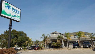 A motel with a sign in front of it.