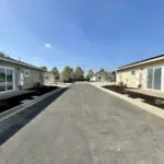 A row of mobile homes in a parking lot.