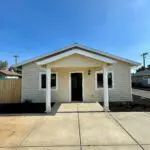 A small house with a white front door.