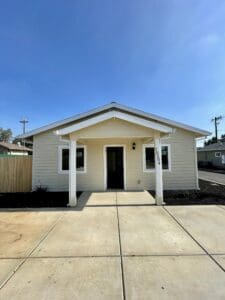 A small house with a white front door.