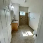 An empty bathroom with a toilet and sink.