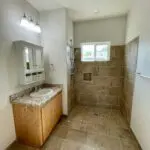 A bathroom with tile floors and a sink.