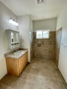 A bathroom with tile floors and a sink.