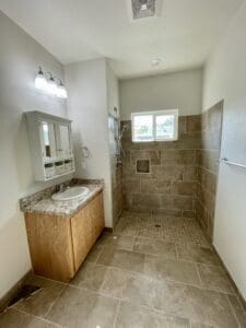 A bathroom with tile floors and a sink.