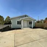 A small house with a driveway and a driveway.