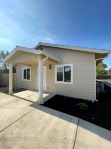 A home with a white siding and a driveway.