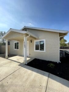 A home with a white siding and a driveway.