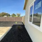 A house with a black fence and a window.