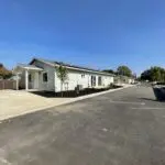 A row of homes with a parking lot in the background.