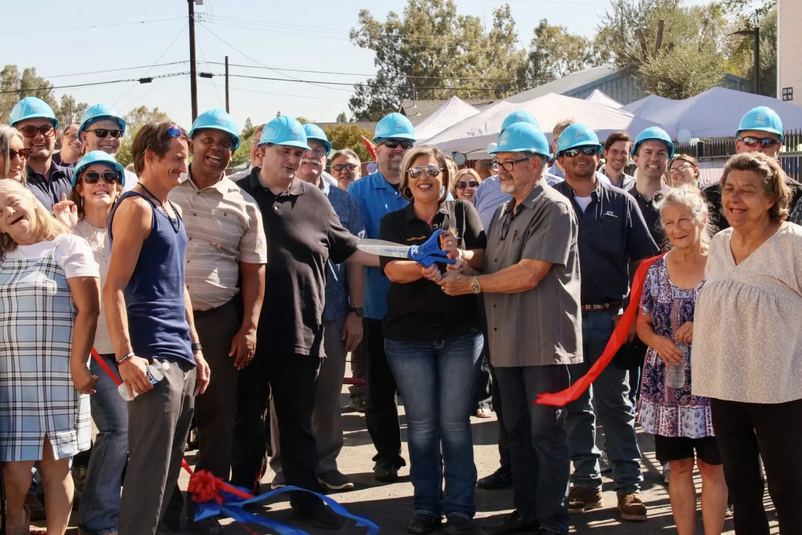 A group of people in hard hats standing in front of a building.