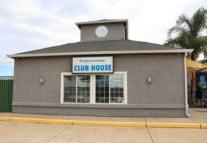 A building with a sign that says club house.