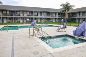 A swimming pool in front of an apartment building.