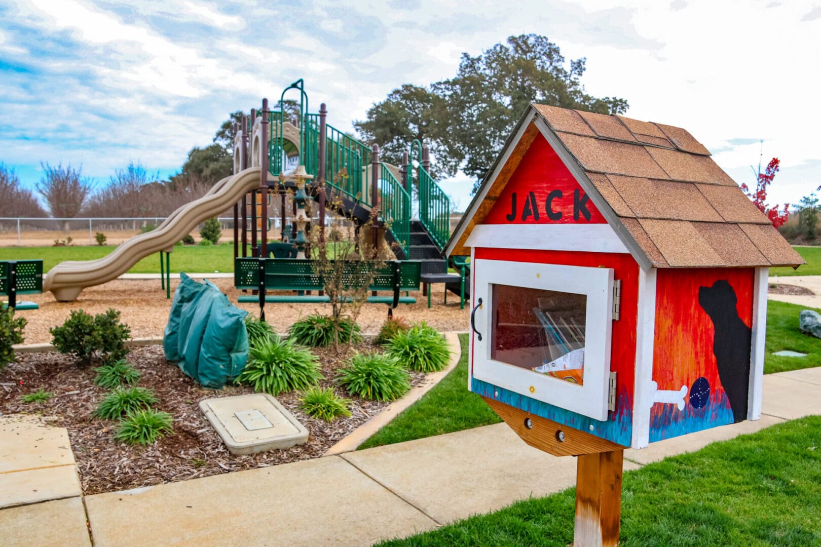 A playground with a swing set and a slide.