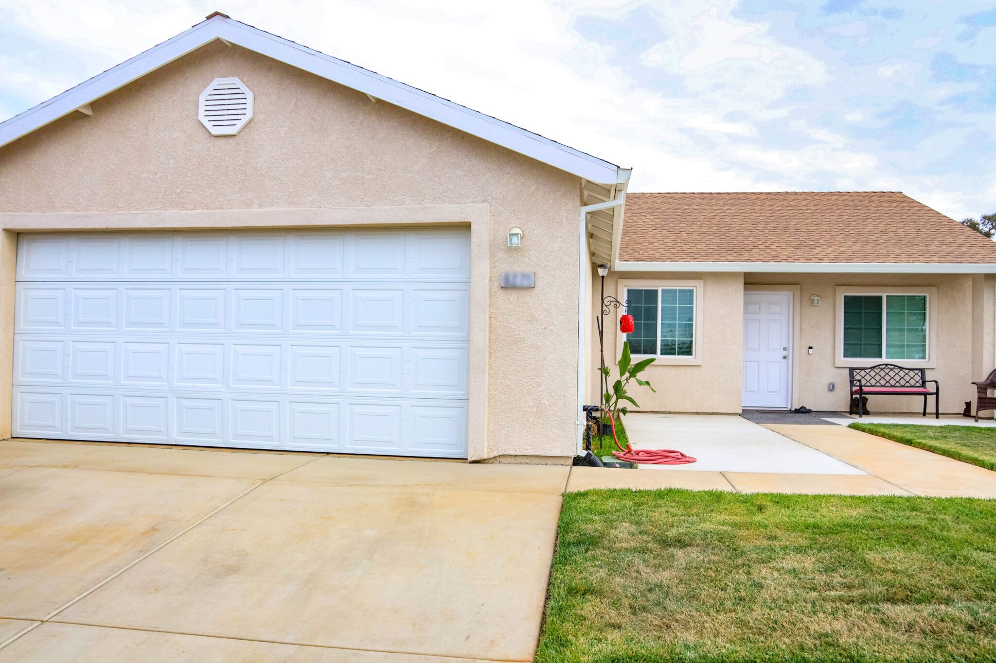 A house with a garage and a lawn.