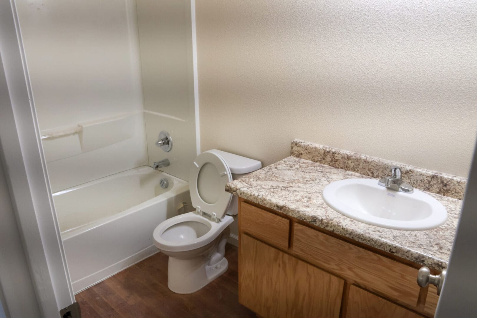 A bathroom with a toilet, sink and tub.