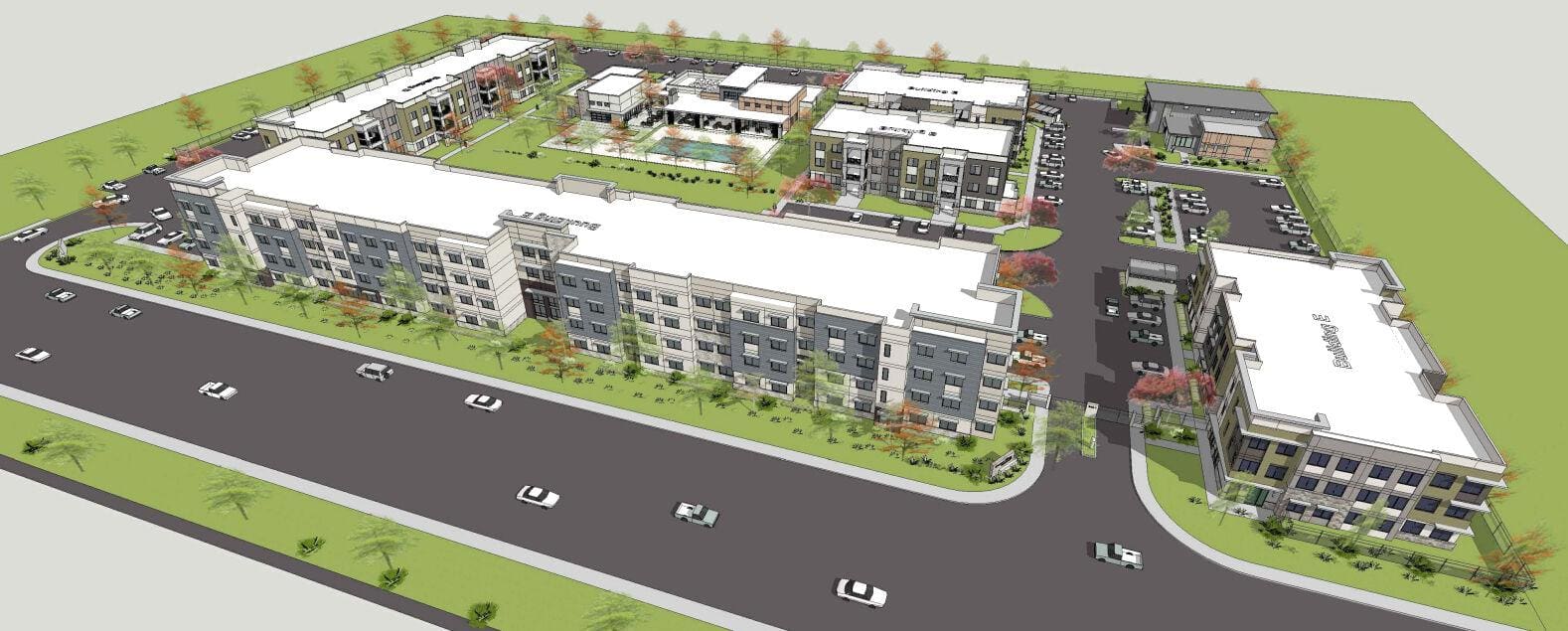 Aerial view of apartment complex with parking lot.