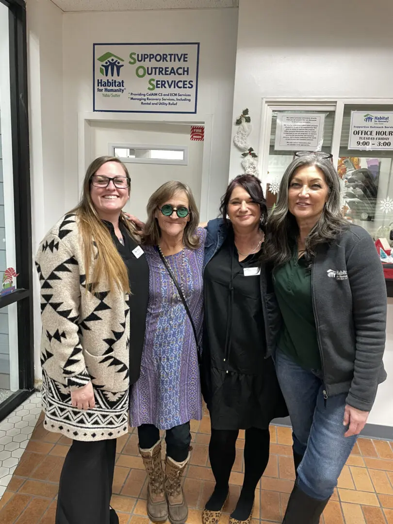 Four women smiling at Habitat for Humanity.