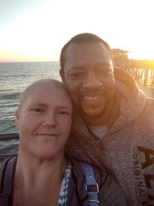 A man and woman post together for a photo