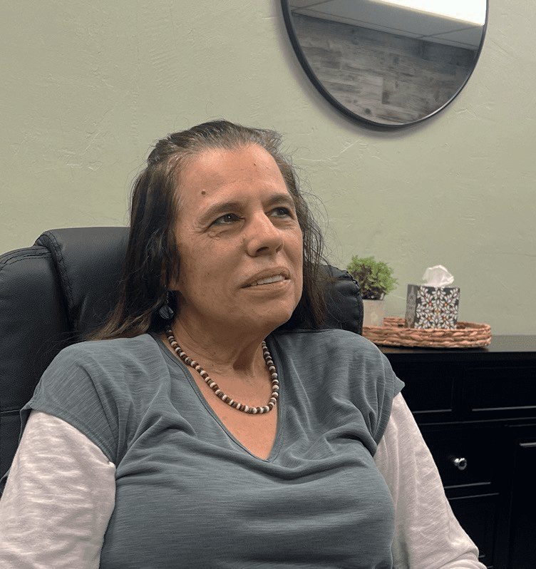 Laurie Sweeney sitting at a Board Room table