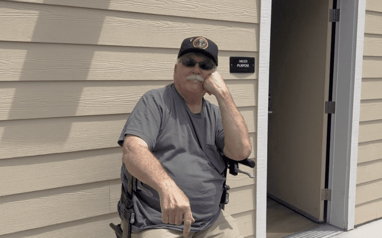 Kenneth sitting outdoors