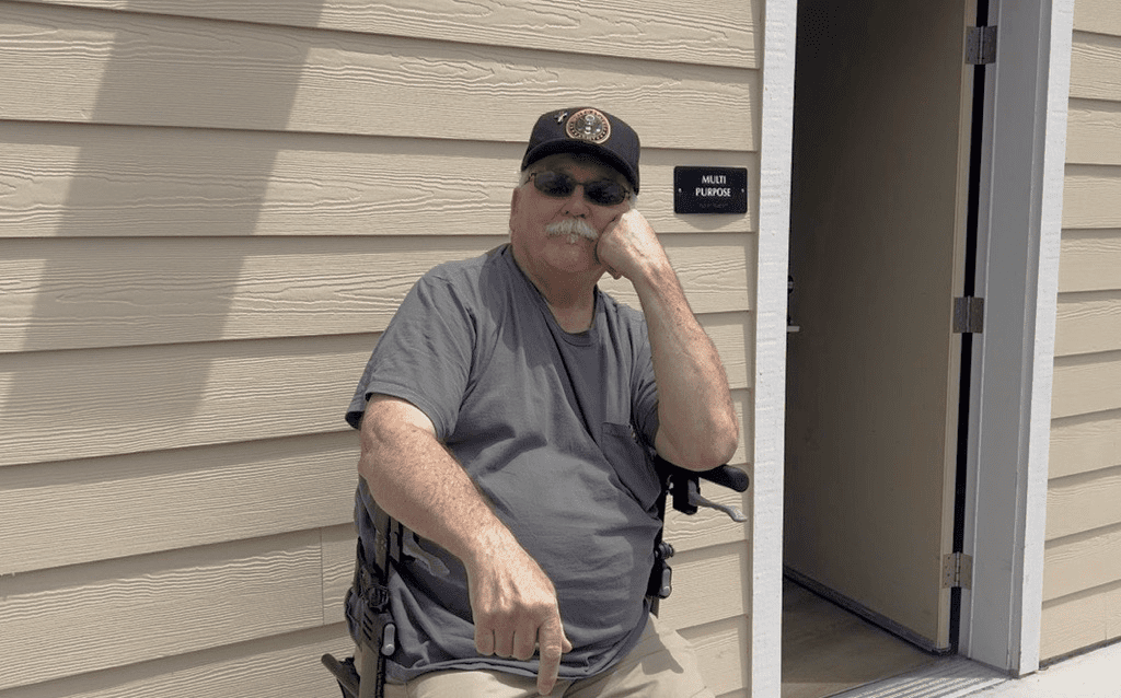 Kenneth sitting outdoors