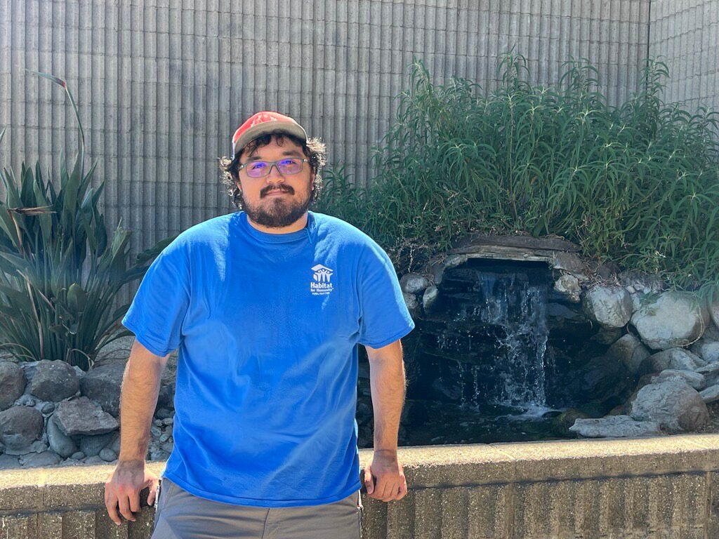 Image of Fransisco standing in front of a fountain